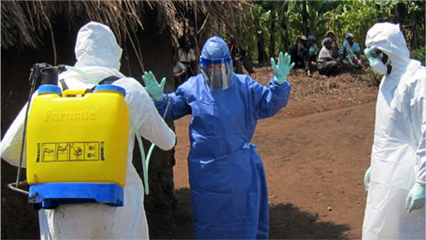 Epidemiologists in Personal Protective Equipment undergoing decontamination while working on an outbreak in the field.