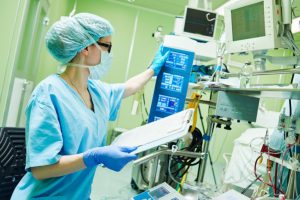 female surgical technologist checks surgical equipment